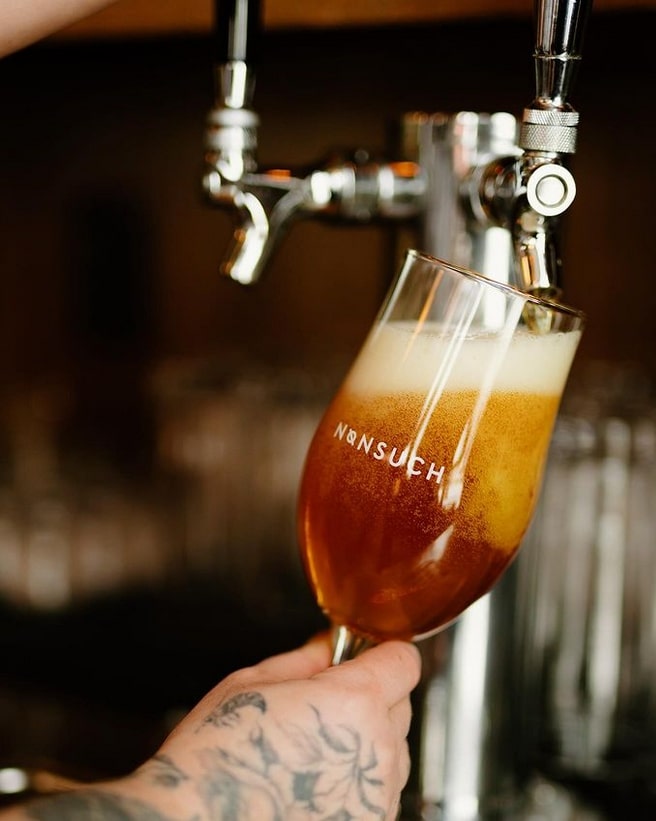 A photo of a beer being poured in Nonsuch taproom in Winnipeg